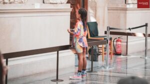Girl child watching stone anticraft at a museum