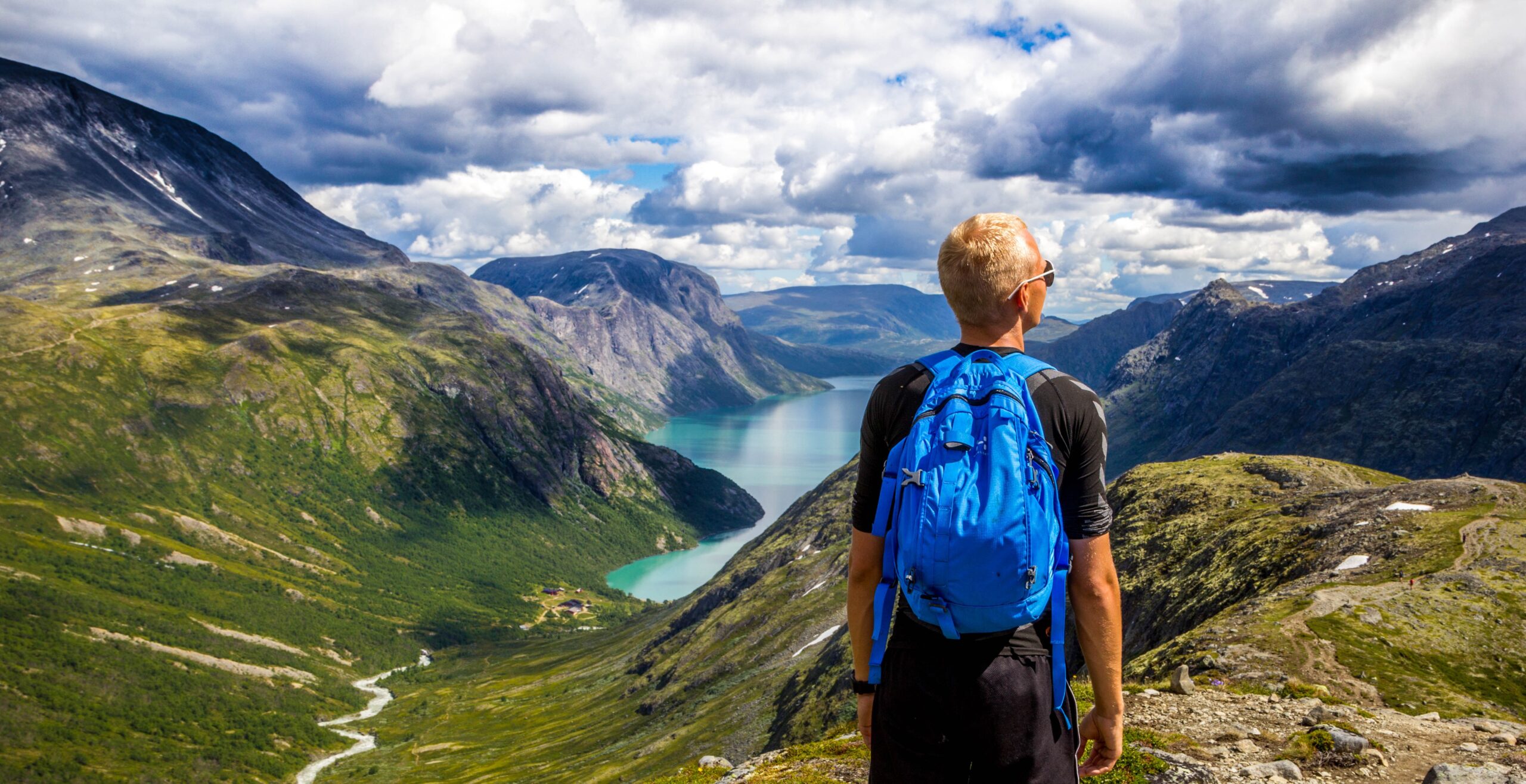 Backpacker overlooking a fjord in the Norwegian mountains