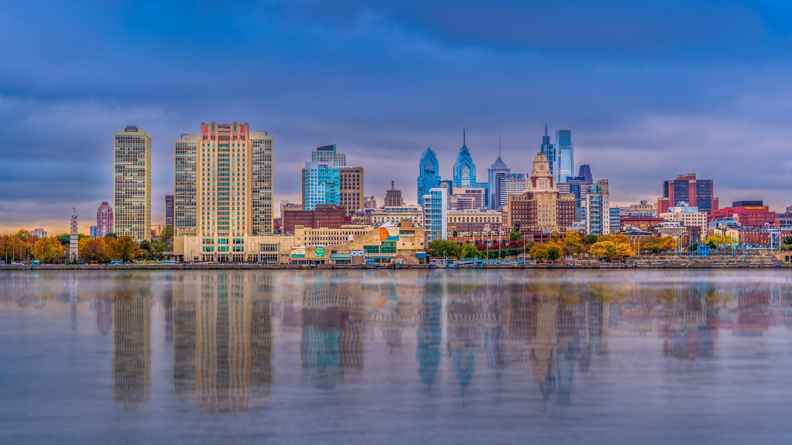 Philadelphia skyline reflected in the river at dusk.