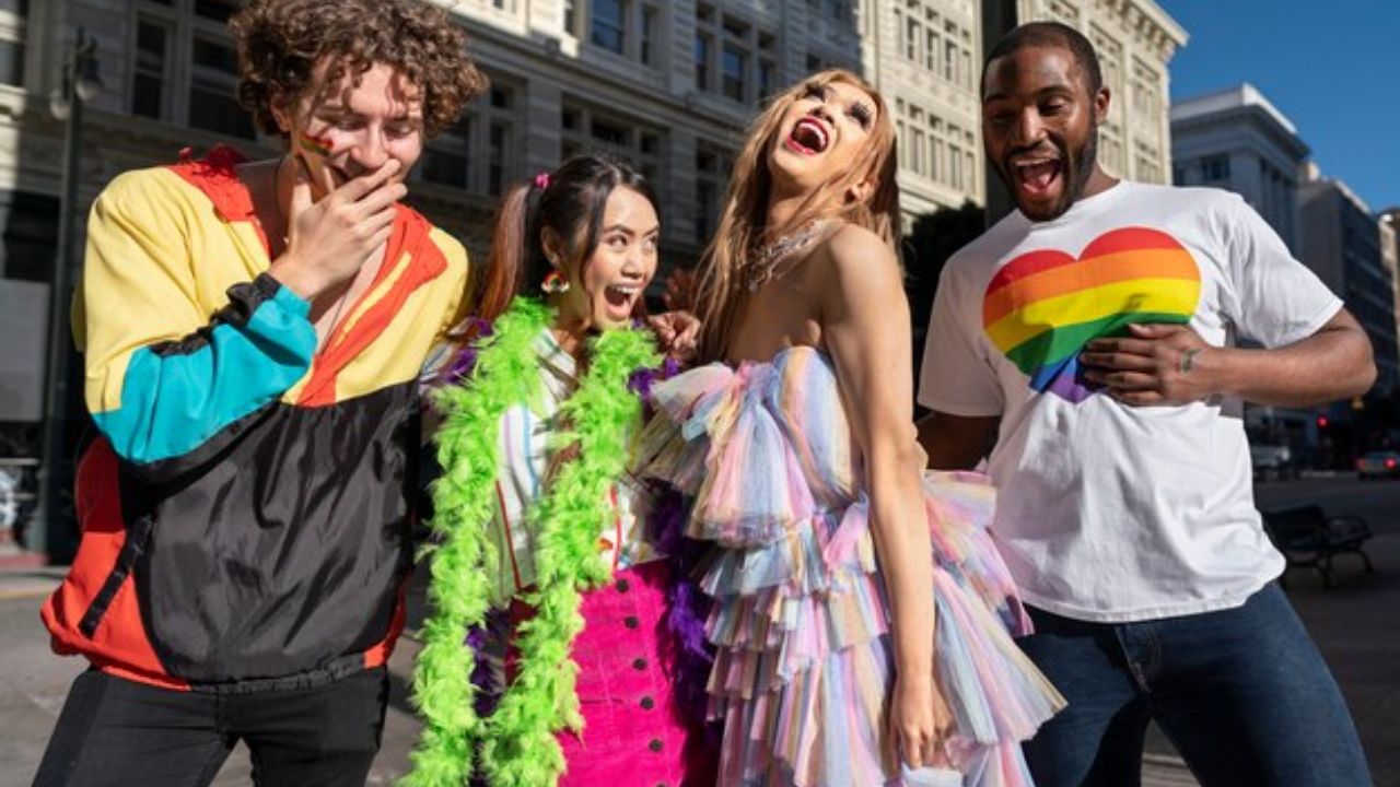 Group of people in rainbow-themed outfits celebrating at NYC Pride March.
