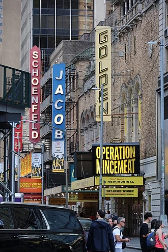 Broadway theaters in NYC with marquees and busy streets.
