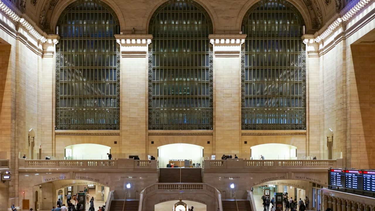 Grand Central Terminal concourse bustling with commuters and clock.
