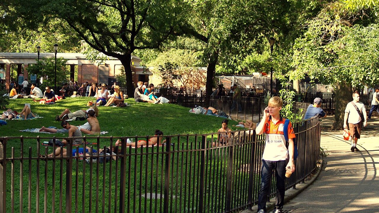 People relaxing in Tompkins Square Park on a sunny day.