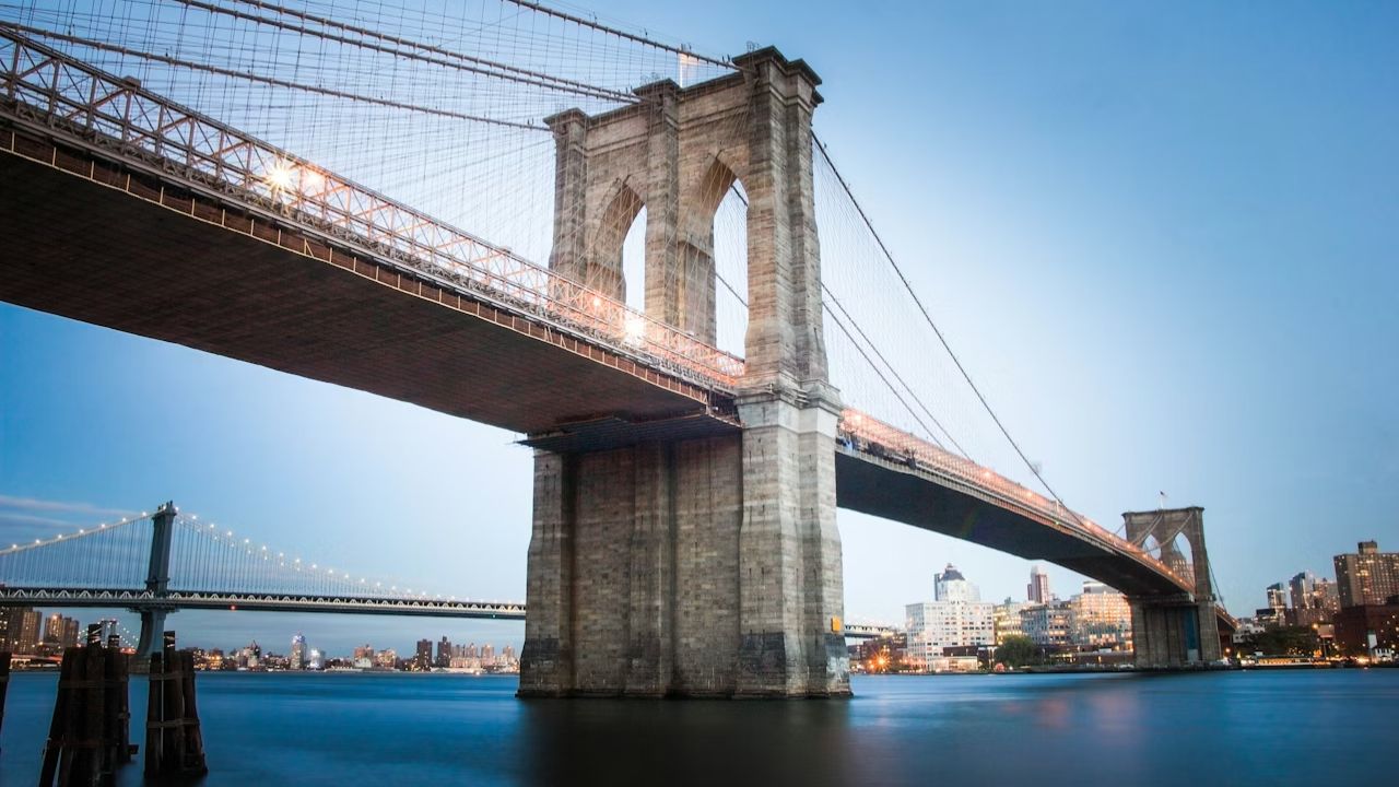 Brooklyn Bridge spanning East River with Manhattan Bridge background.