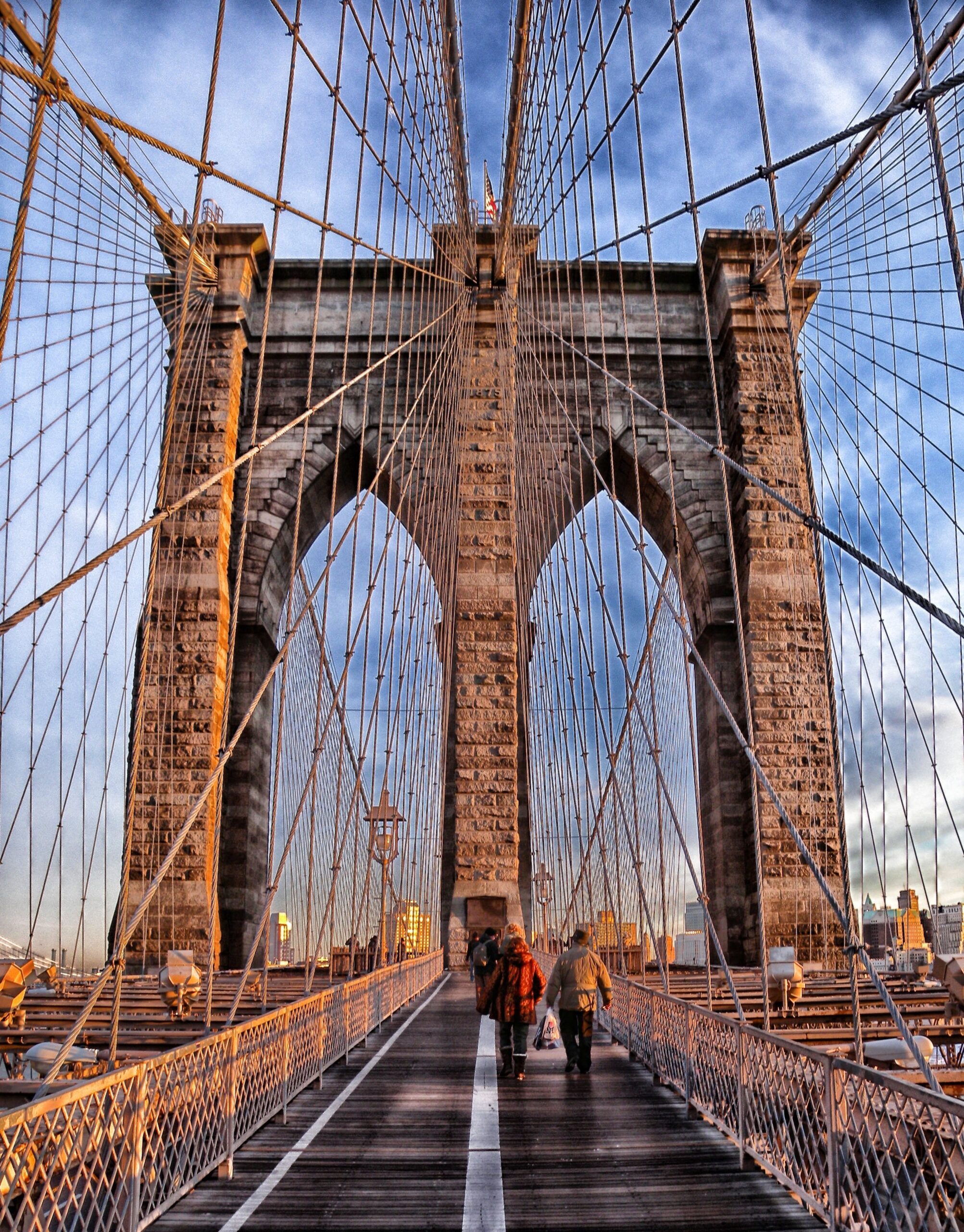 Brooklyn Bridge stretching across the East River with the Manhattan skyline visible in the background