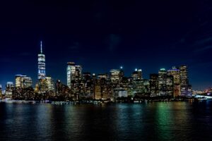 Downtown NYC streets glowing with nightlife and city lights.