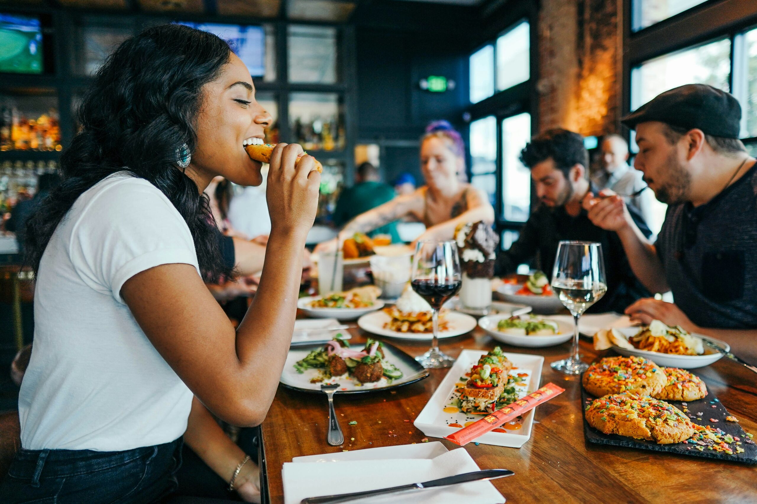 Group dining together at a restaurant table with shared dishes.