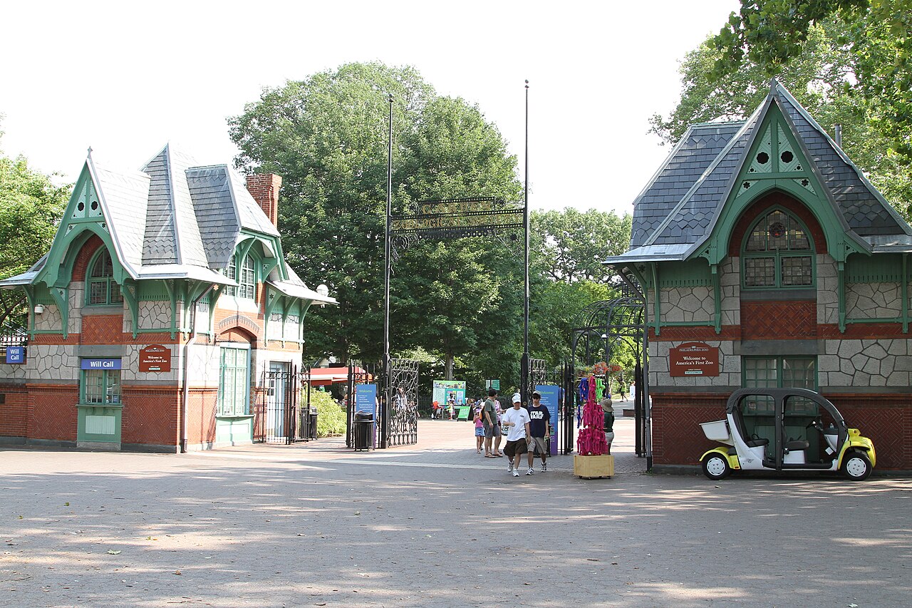 Historic gatehouse entrance of Philadelphia Zoo with visitors.