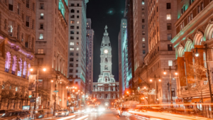 Philadelphia City Hall illuminated at night with light trails.