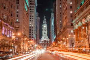 Philadelphia City Hall illuminated in vibrant nighttime cityscape.