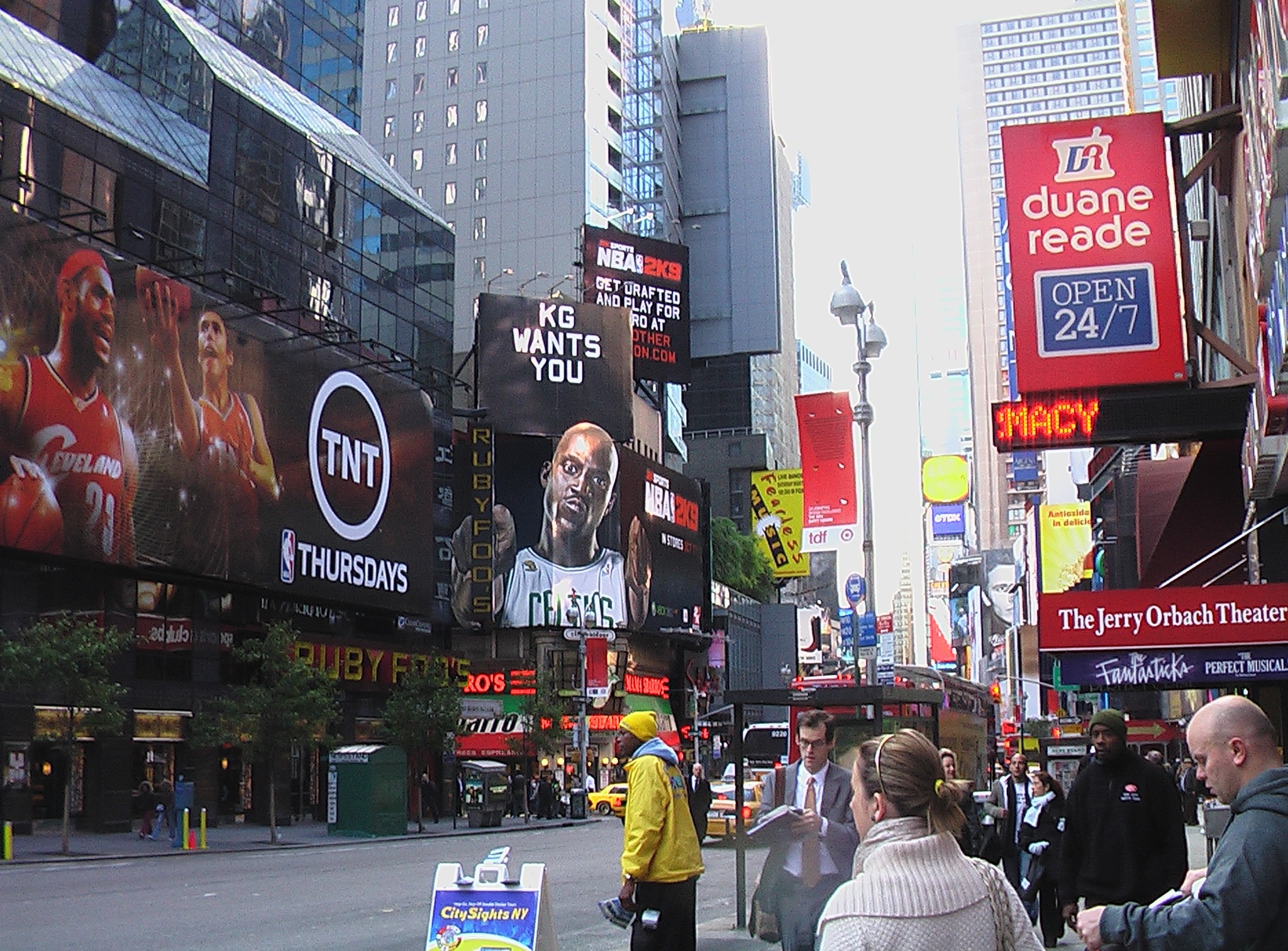 Times Square street scene featuring large billboards advertising NBA 2K9 video game, TNT NBA Thursdays, and a Duane Reade pharmacy