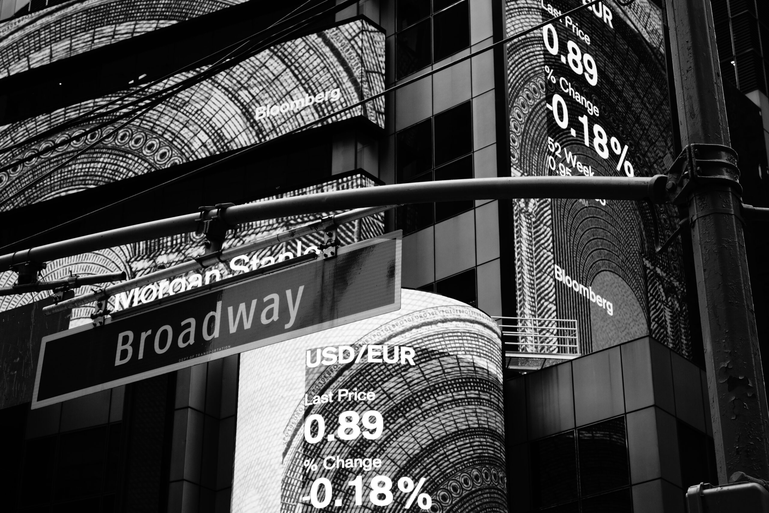 Black and white Broadway street sign with Bloomberg displays