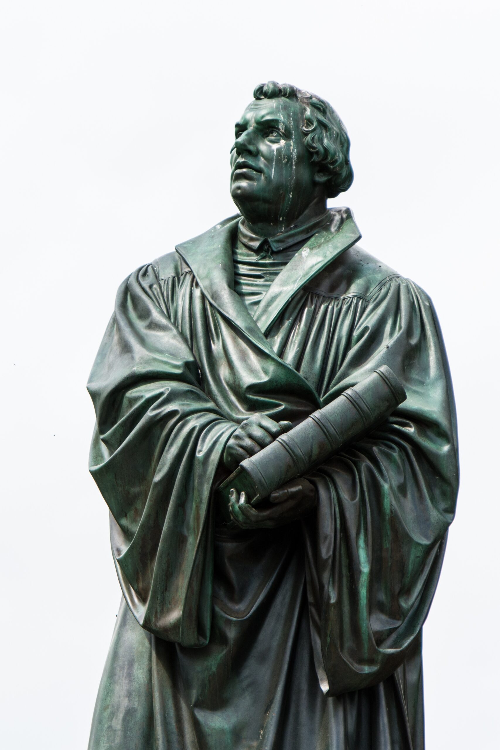 Bronze statue of Martin Luther holding book, looking up