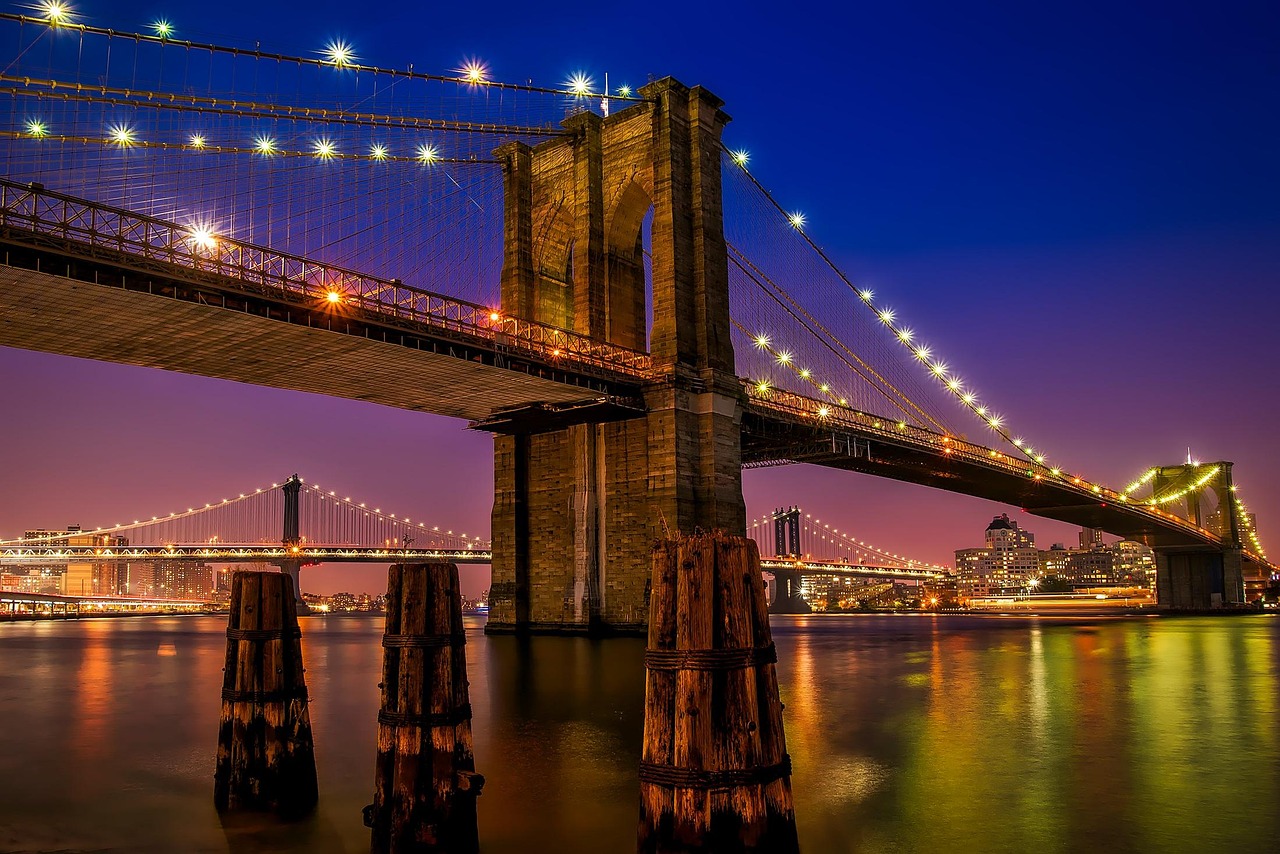 Brooklyn Bridge illuminated at night over East River