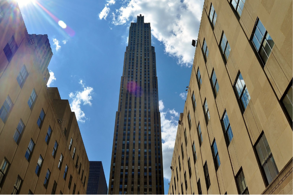 Rockefeller Center tower viewed upward between buildings