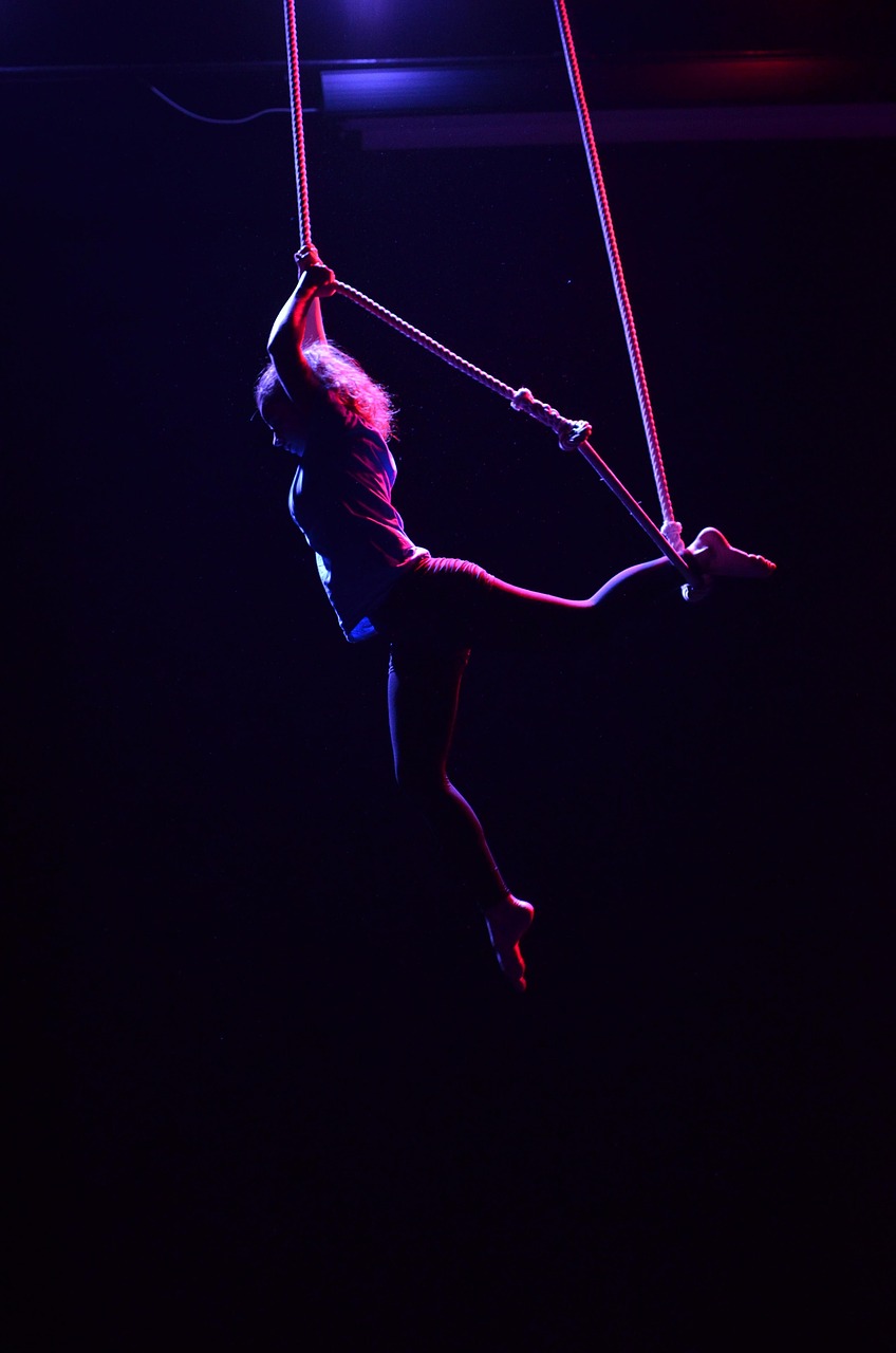 Student practicing aerial ropes indoors
