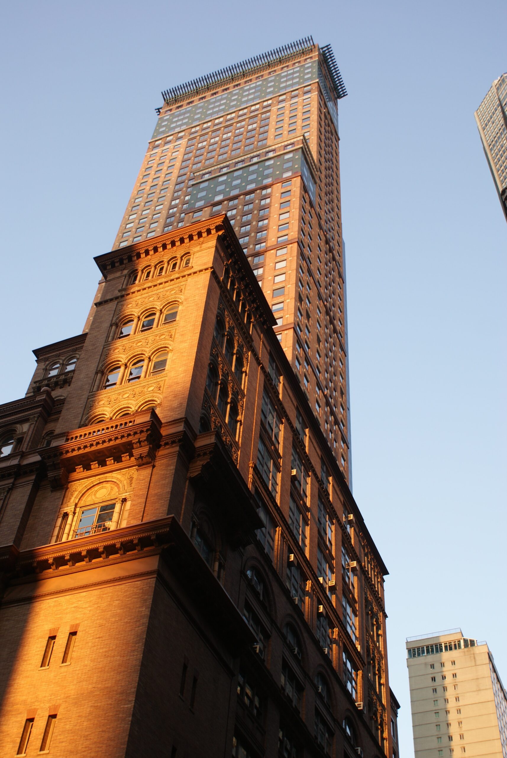 Tall skyscraper rising above historic ornate building