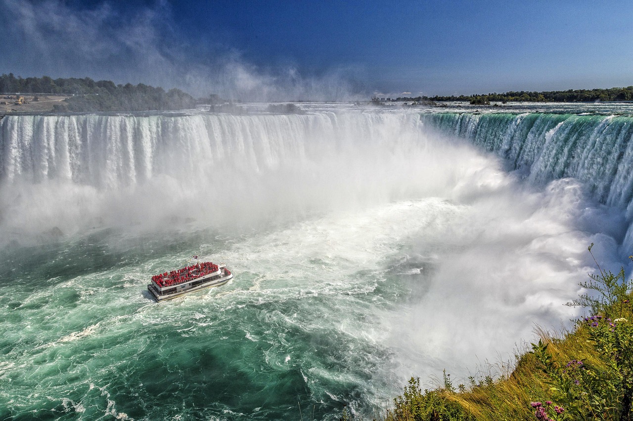 Tour boat approaching Niagara Falls' powerful horseshoe cascade