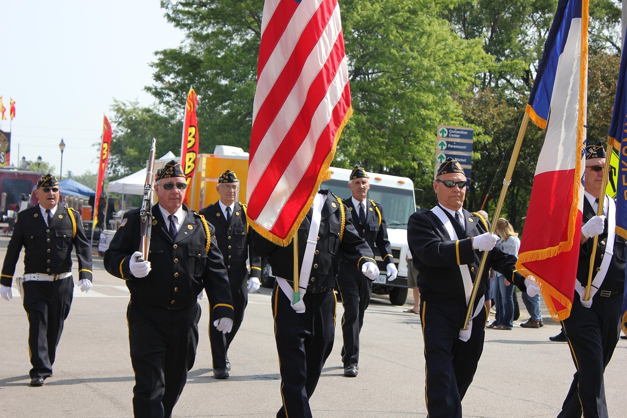 Veterans marching with American flags in parade