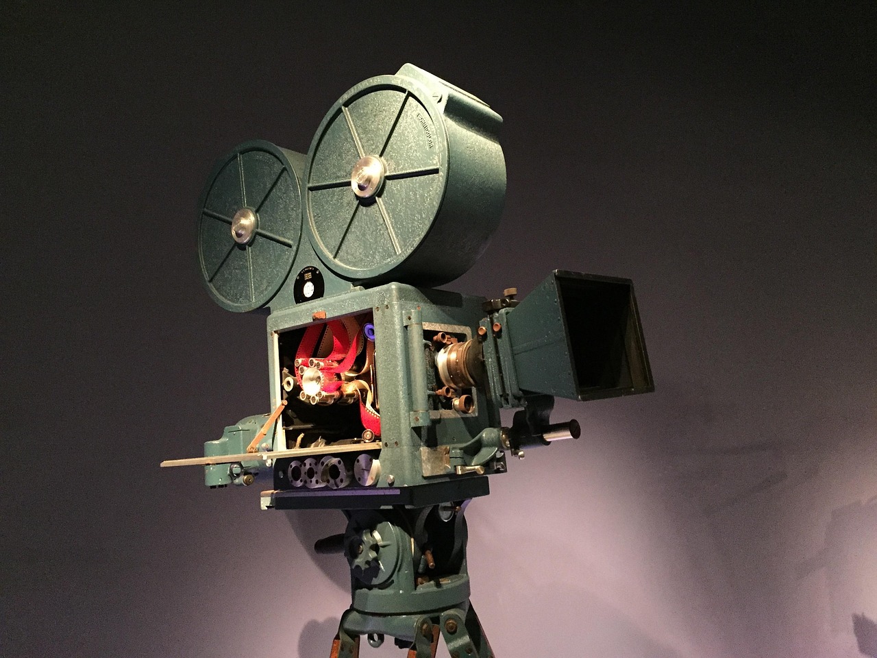 Vintage film camera with red reels on tripod