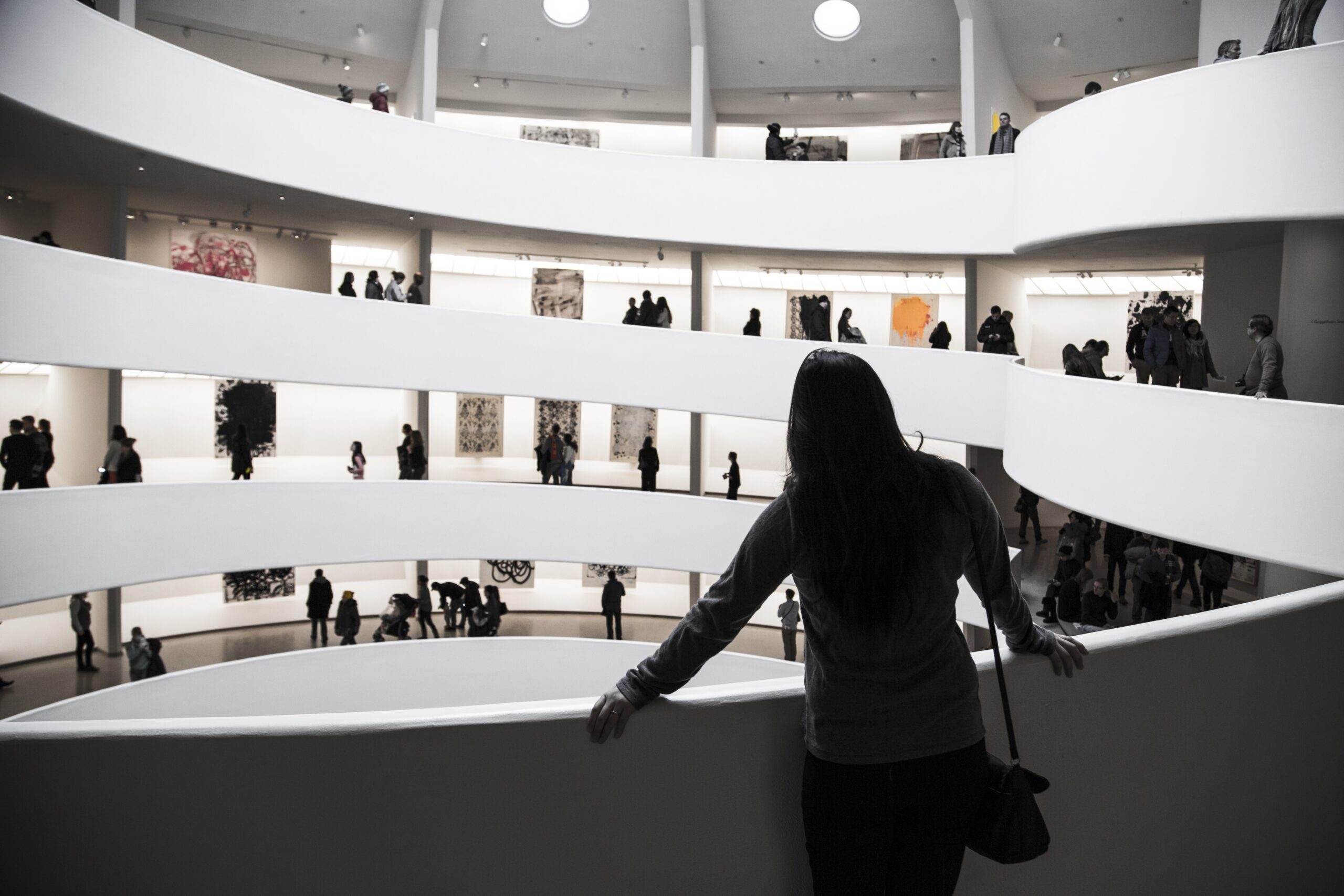 Visitor overlooking a museum's spiral gallery interior