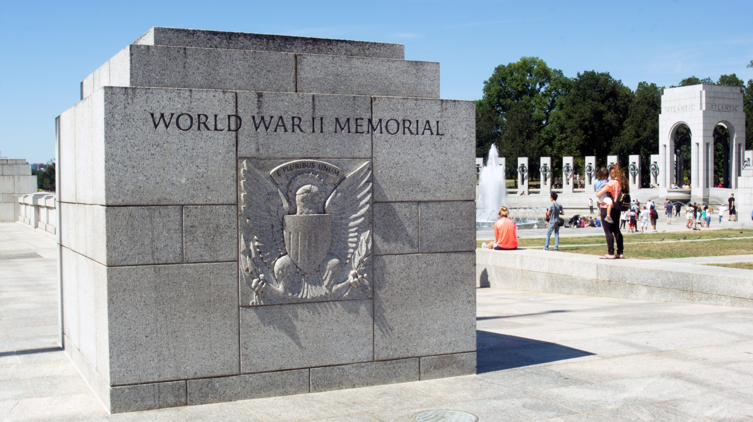 World War II Memorial wall with fountain in background