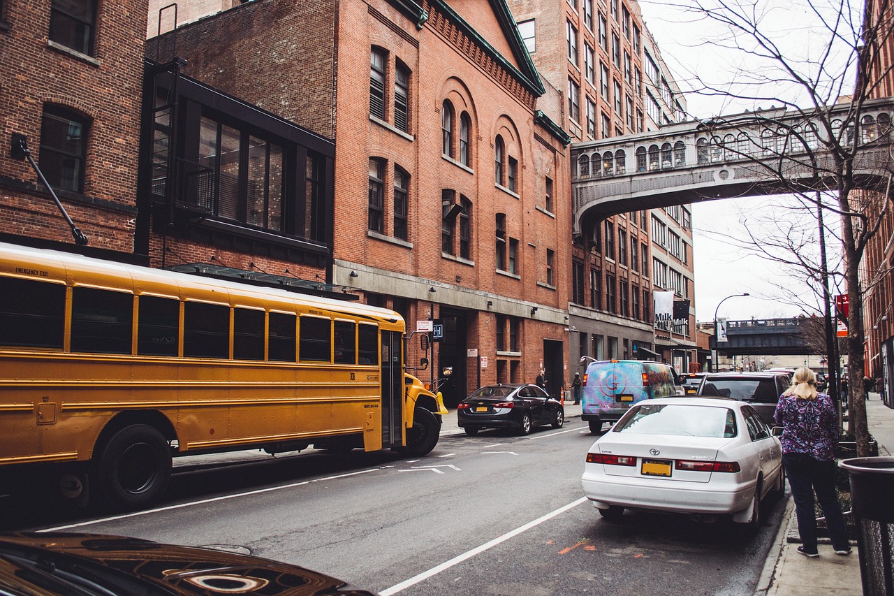 Yellow school bus parked on Chelsea brick street