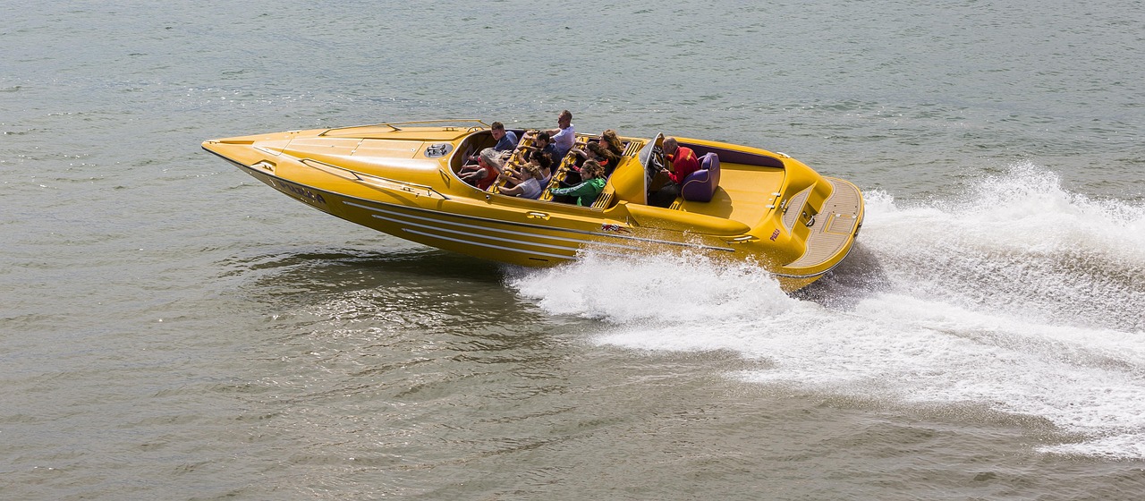 Yellow speedboat carrying passengers across the water
