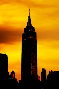 Empire State Building silhouette against a fiery sunset sky