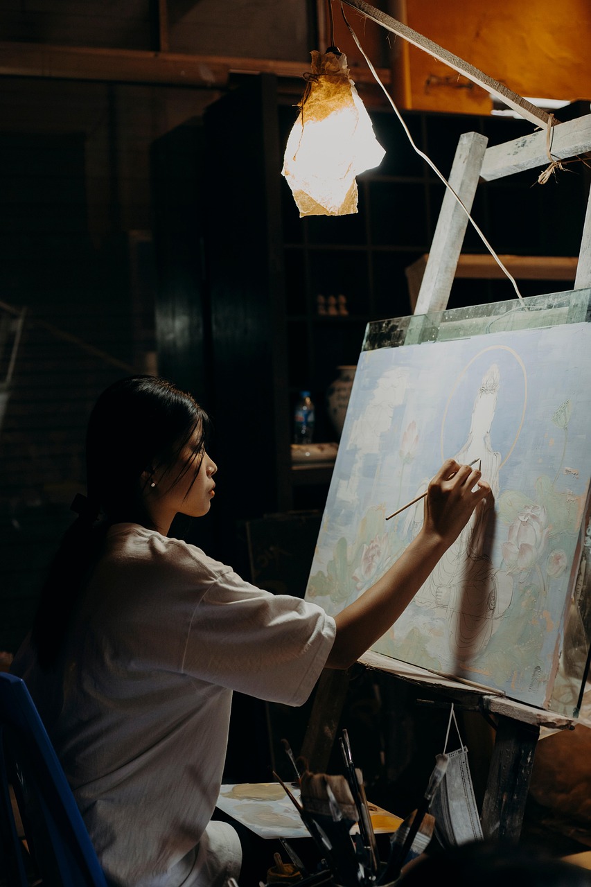 Artist painting a figure on canvas by lamplight