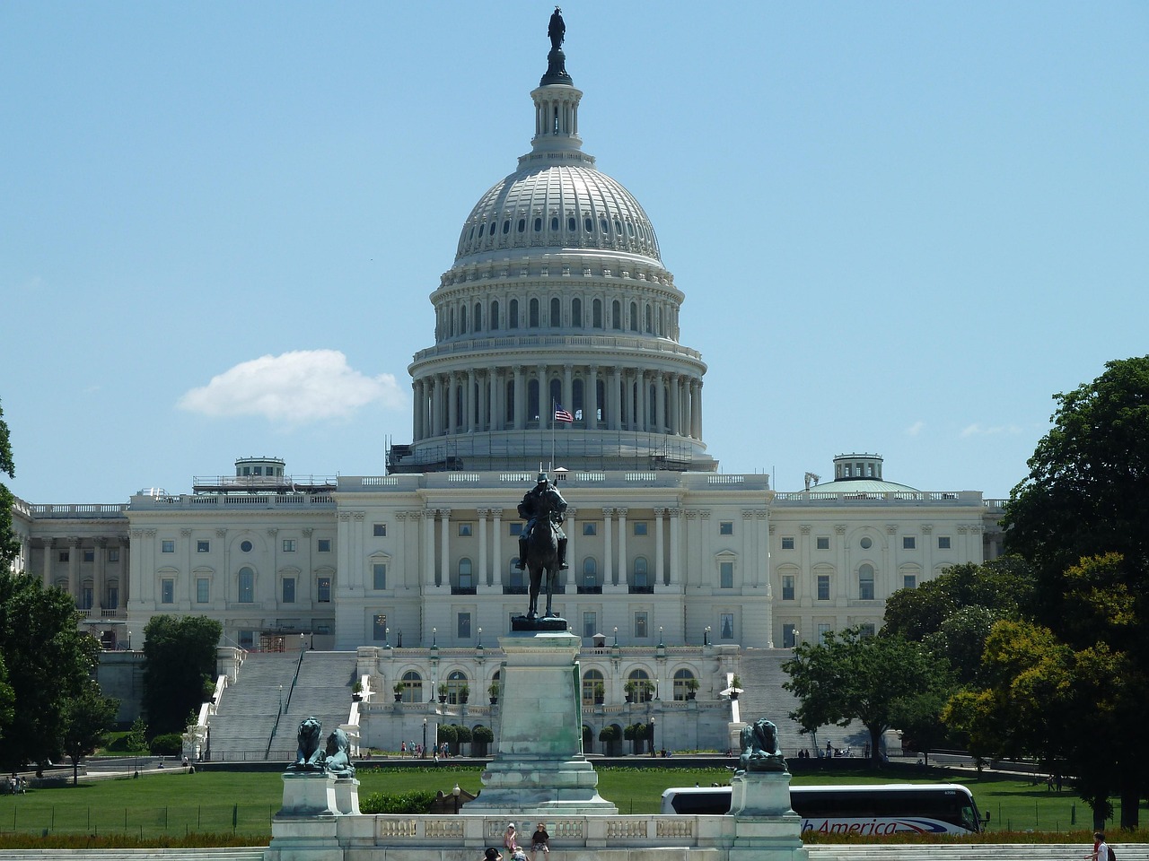 Capitol building viewed across the lawn, with equestrian statue