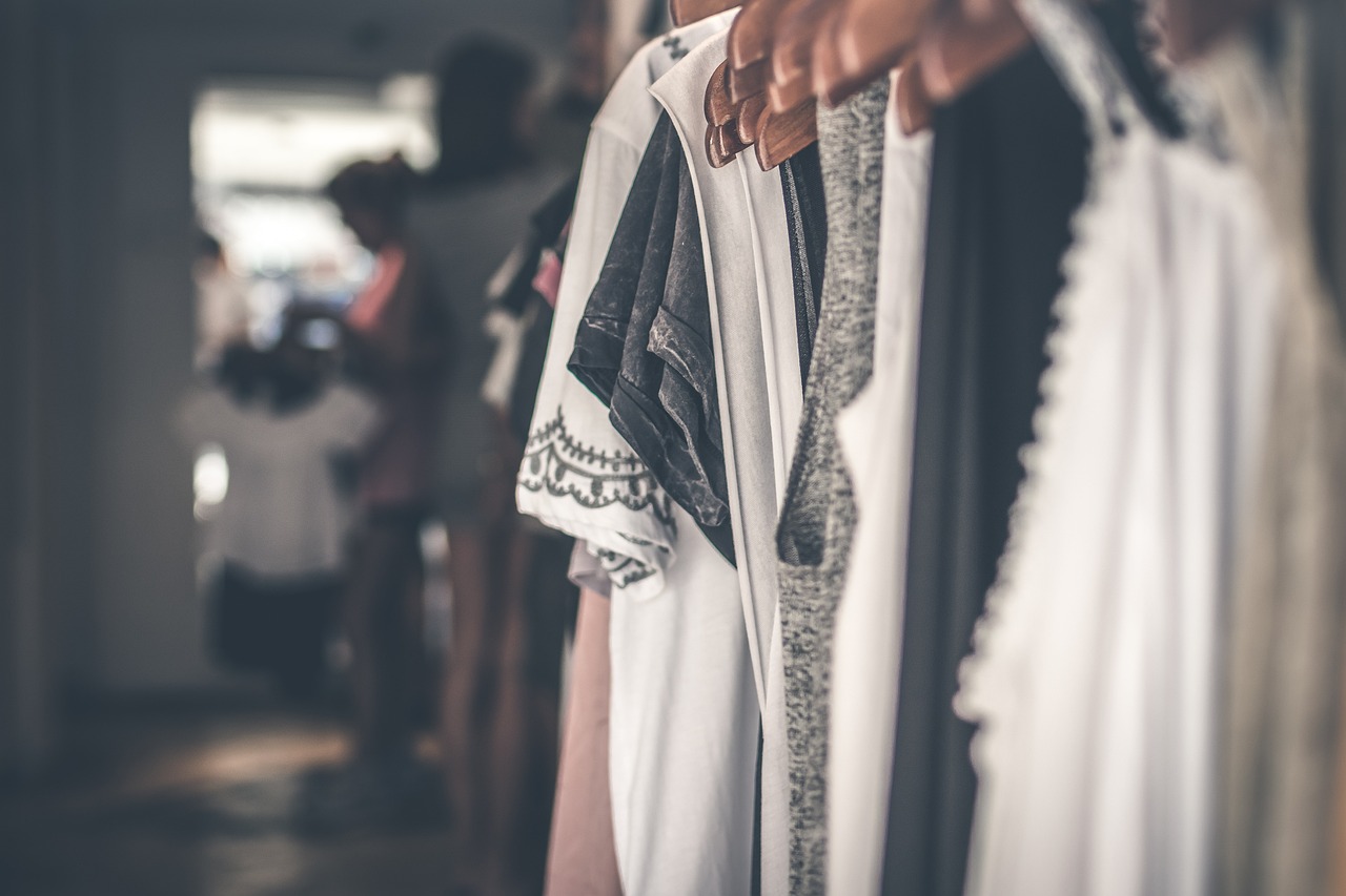 Clothes hanging on wooden hangers in a boutique