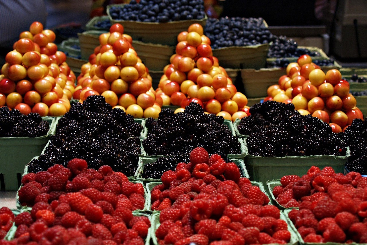 Colorful berries and cherries arranged in market baskets