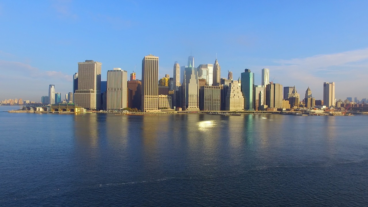 Lower Manhattan skyline reflected across the water